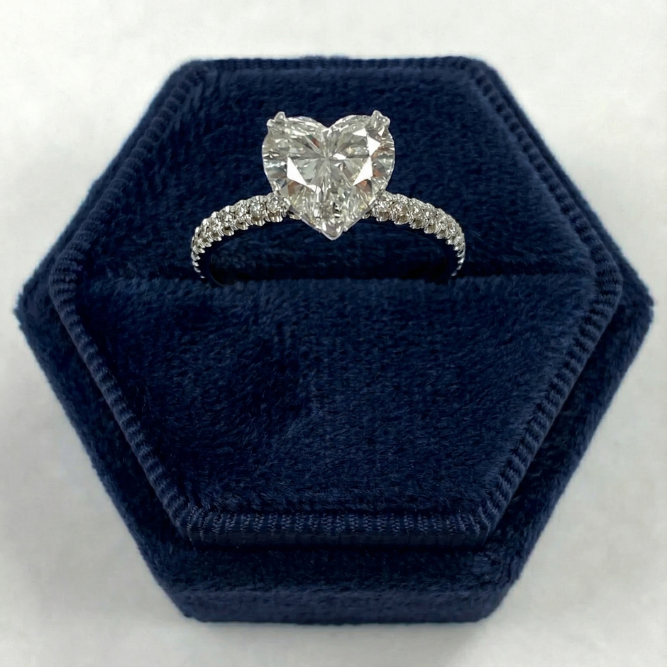 Heart-shaped Simulated diamond ring in a hexagonal blue velvet box on a white background