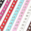 Set of colorful pet collars with rhinestone embellishments on a white background