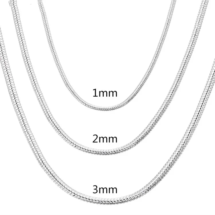 Three silver chain necklaces of different thicknesses on a white background