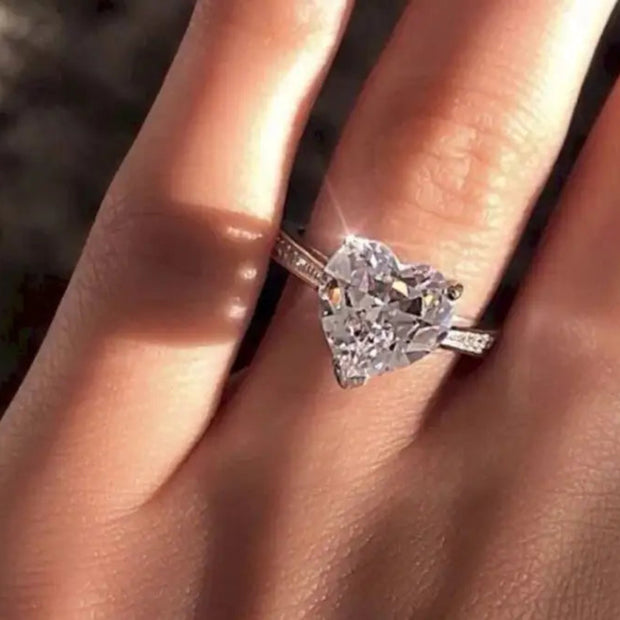 Simulated  Diamond ring on a finger with a blurred background