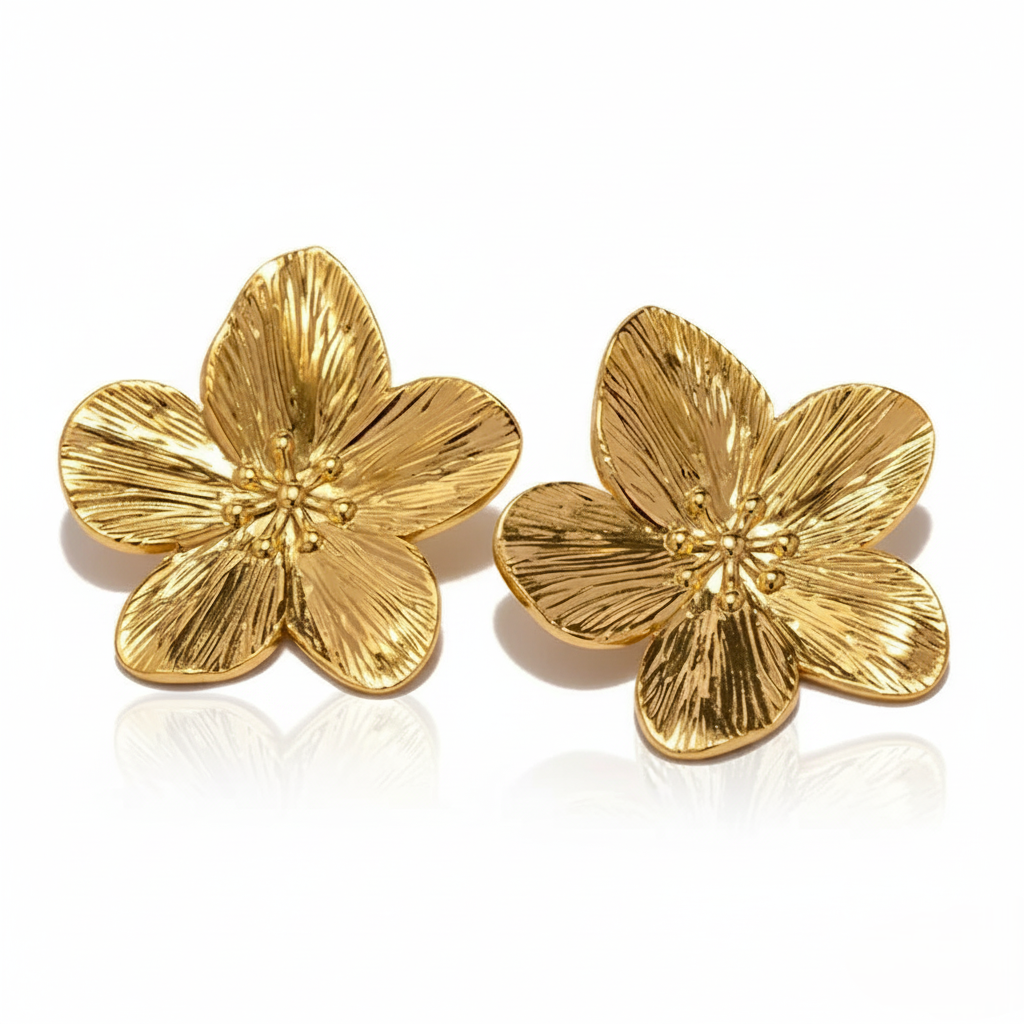 Pair of gold flower-shaped earrings on a white background