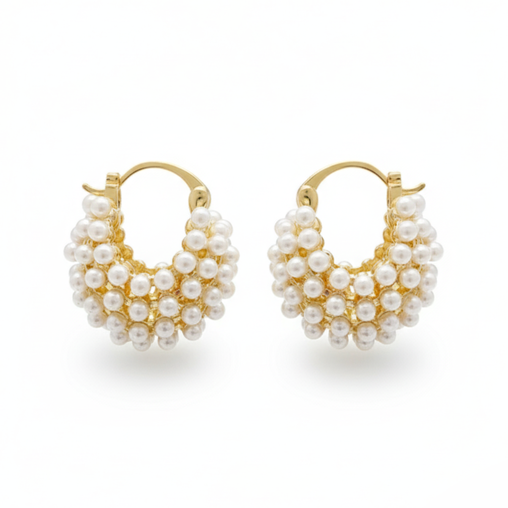 Pair of gold hoop earrings with pearl-like beads on a white background