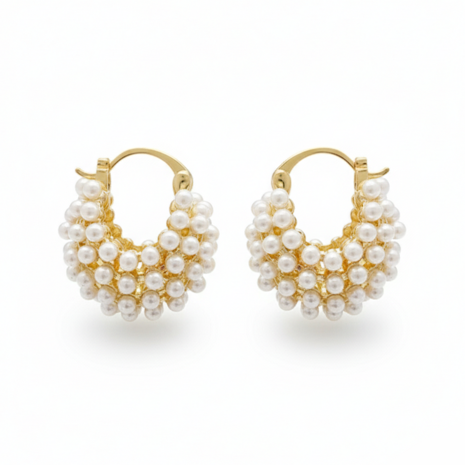 Pair of gold hoop earrings with pearl-like beads on a white background