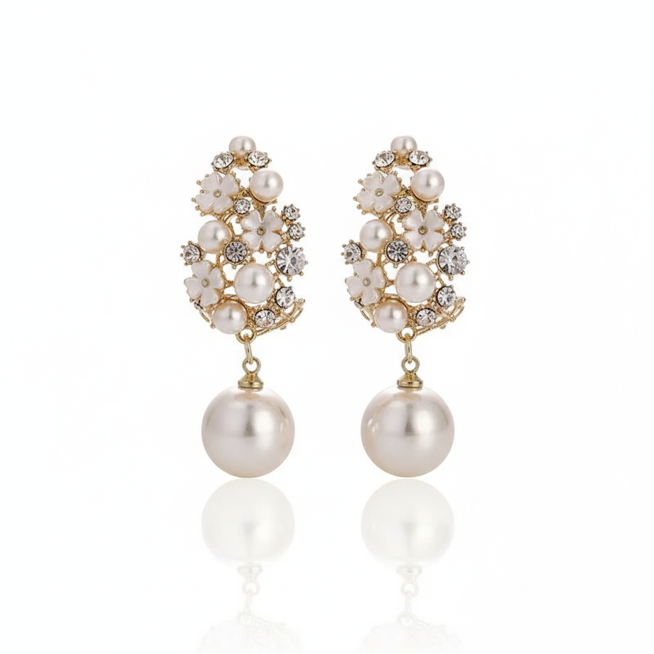Pair of pearl earrings with gold accents on a white background
