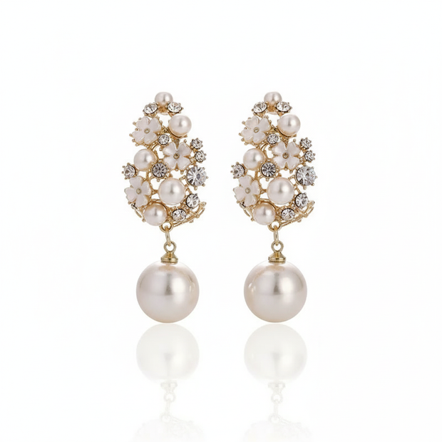 Pair of pearl earrings with gold accents on a white background