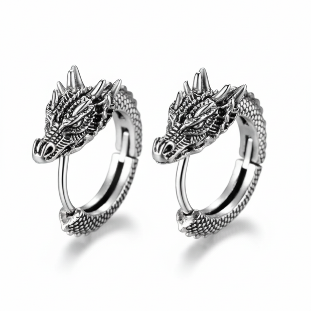 Pair of silver dragon hoop earrings on a white background