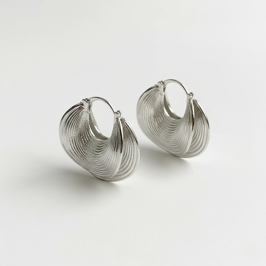 Pair of silver hoop earrings on a light gray background