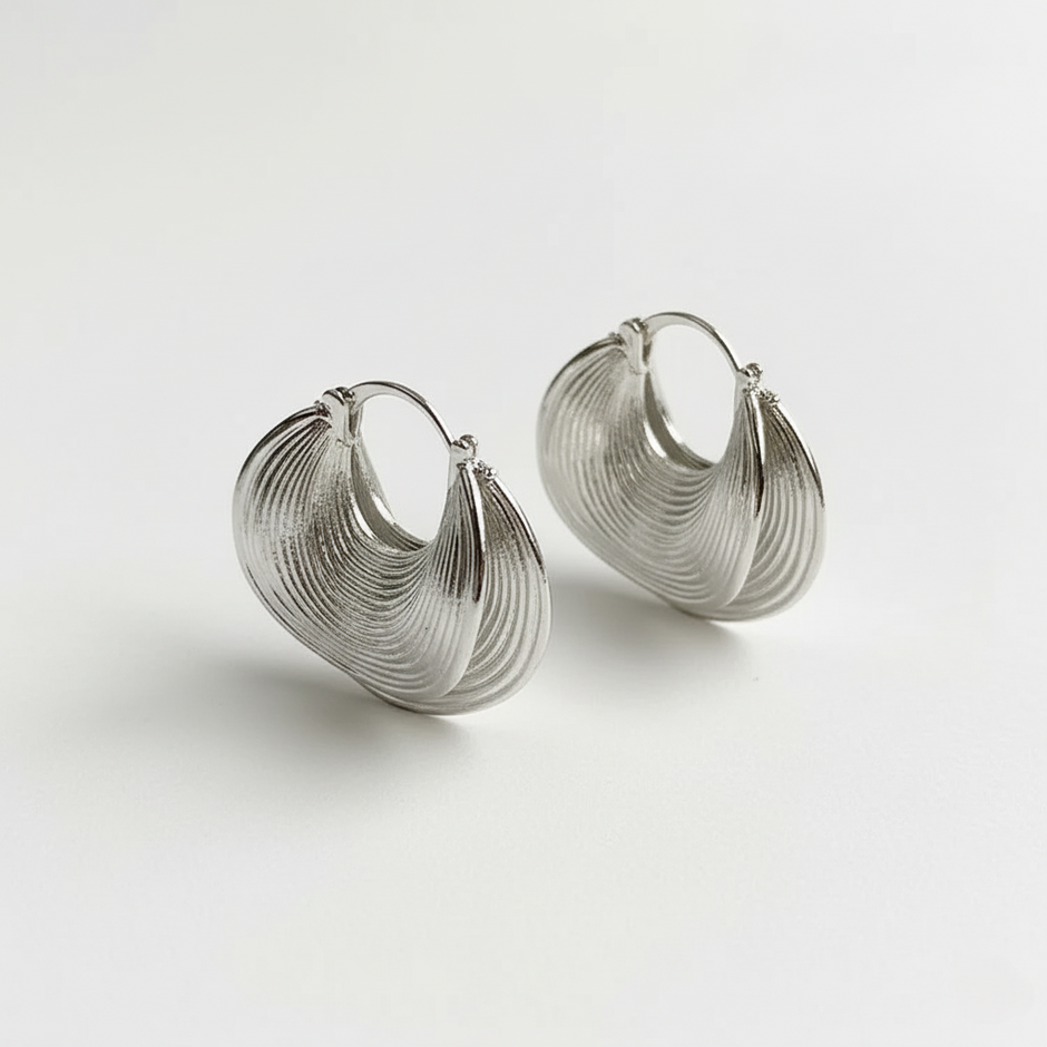 Pair of silver hoop earrings on a light gray background