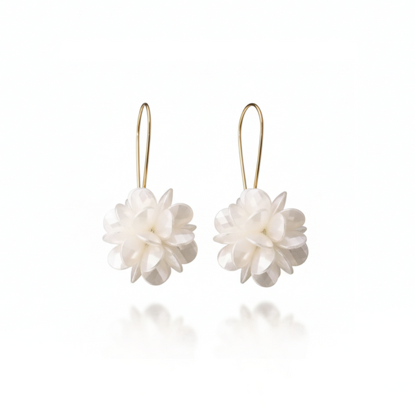 Pair of white floral earrings on gold hooks against a white background
