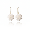 Pair of white floral earrings on gold hooks against a white background