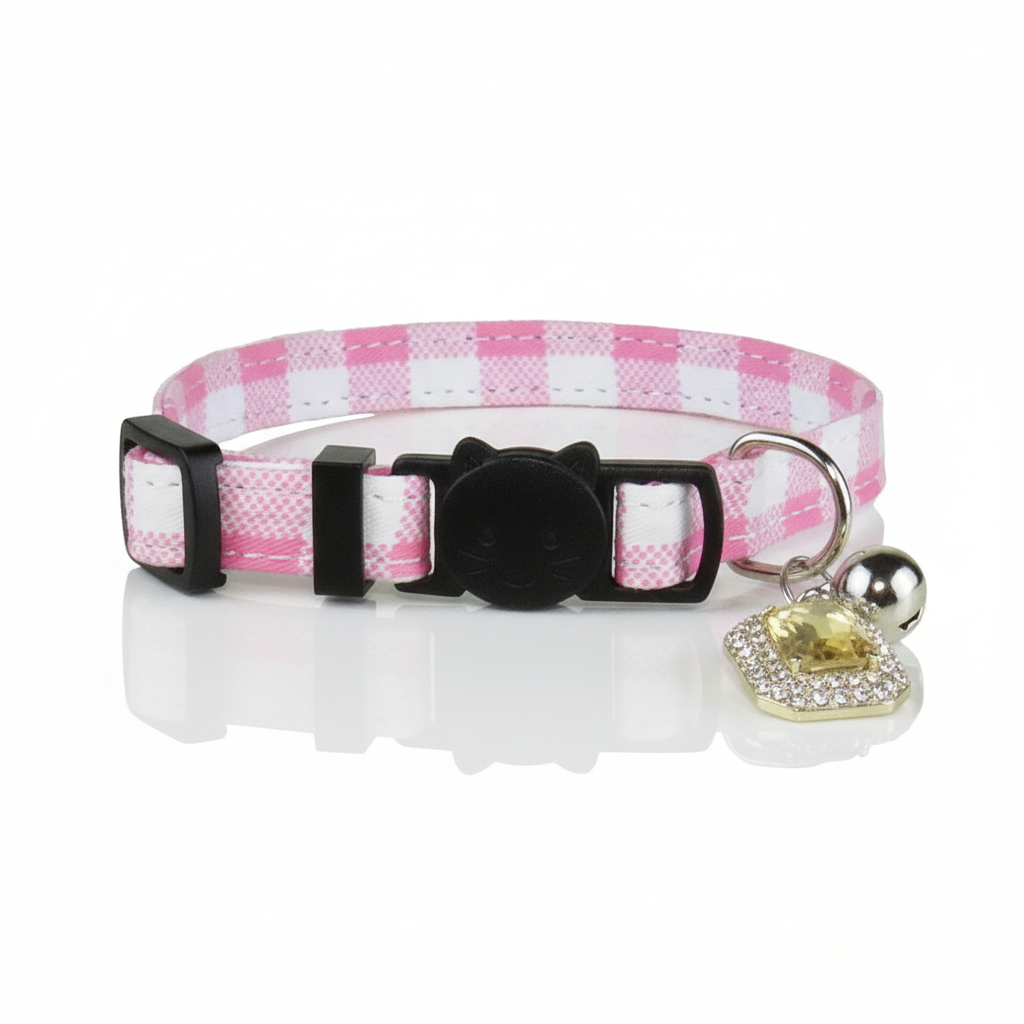 Pink and white checkered cat collar with a black buckle and heart-shaped tag on a white background
