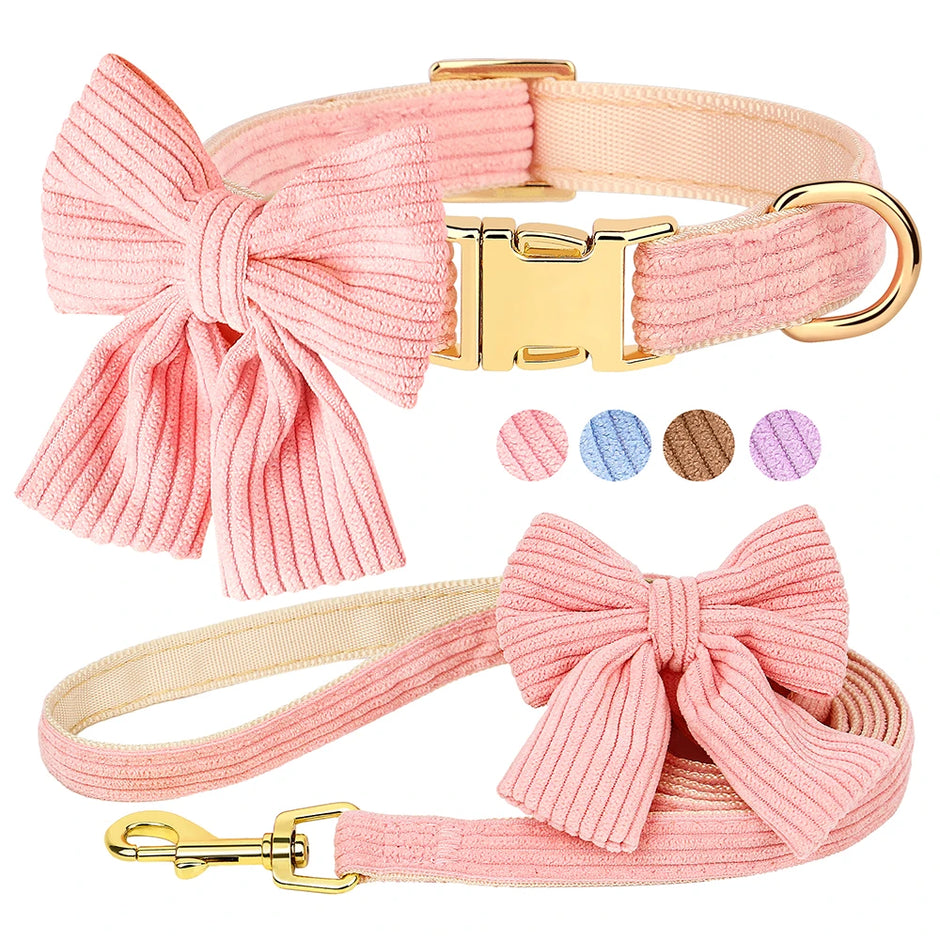 Pink dog collar and leash set with a bow design on a white background