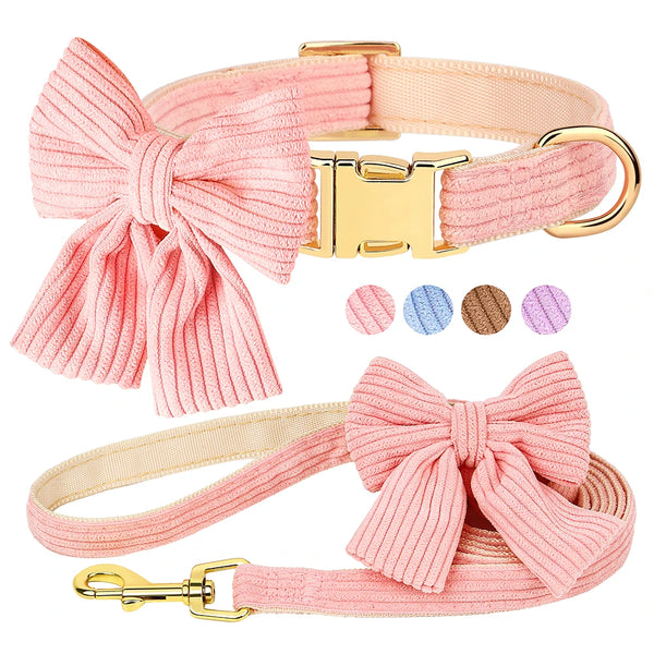 Pink dog collar and leash set with a bow design on a white background
