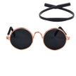 Round sunglasses with rose gold frame and black lenses on a white background