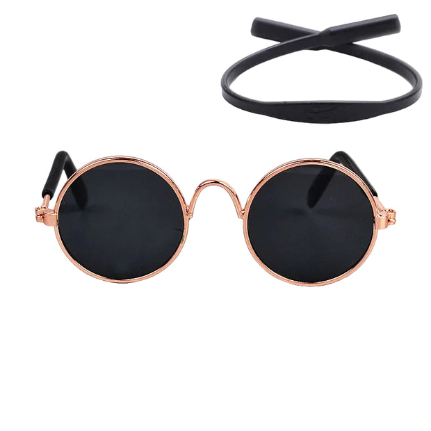 Round sunglasses with rose gold frame and black lenses on a white background