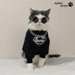 Cat wearing a black outfit with a Superman logo and sunglasses, branded 'Puppy Style'.