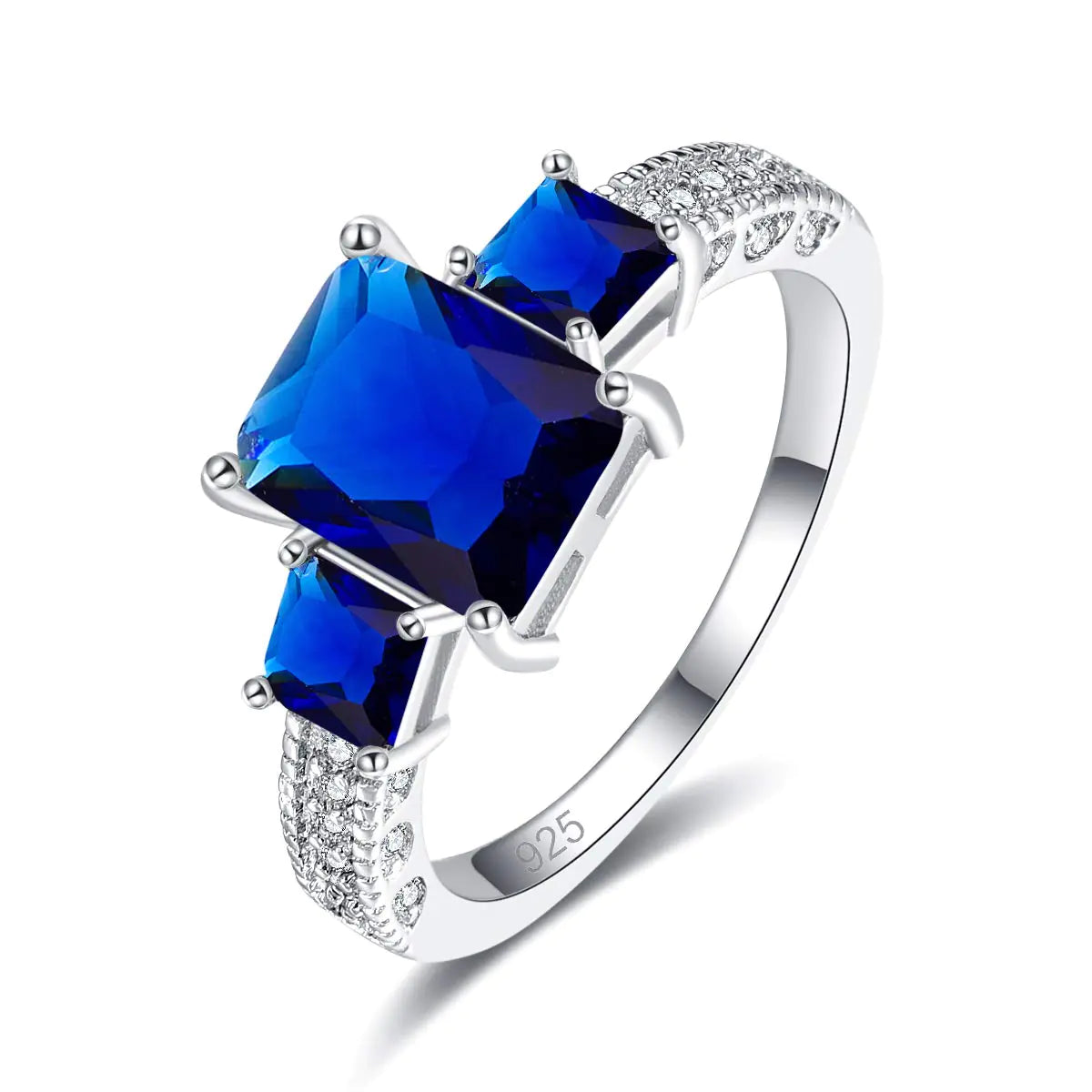 three-stone promise ring
 with a large blue gemstone on a white background