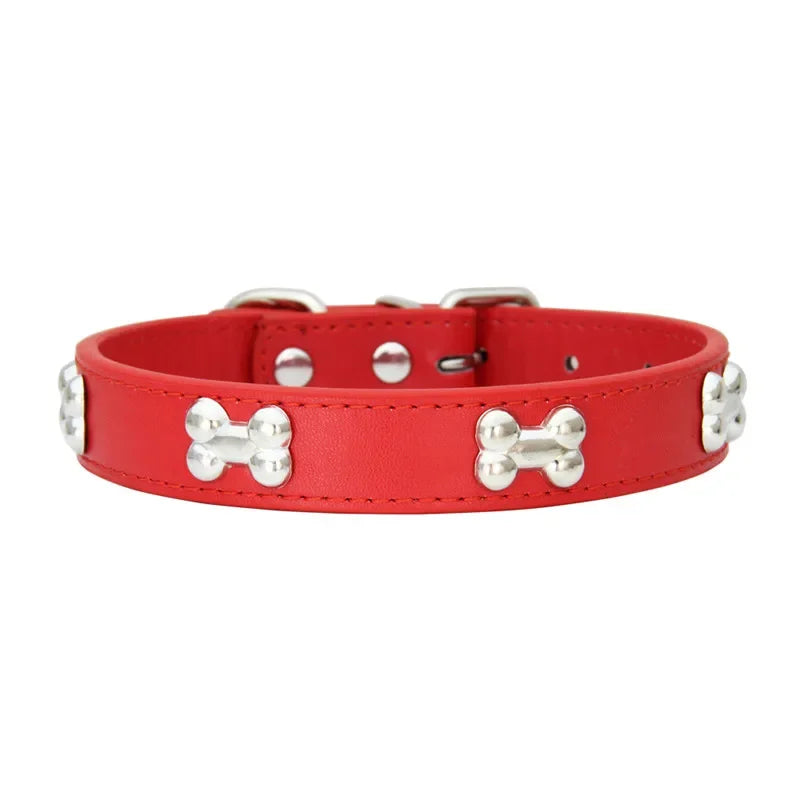 Red dog collar with silver bone-shaped studs on a white background