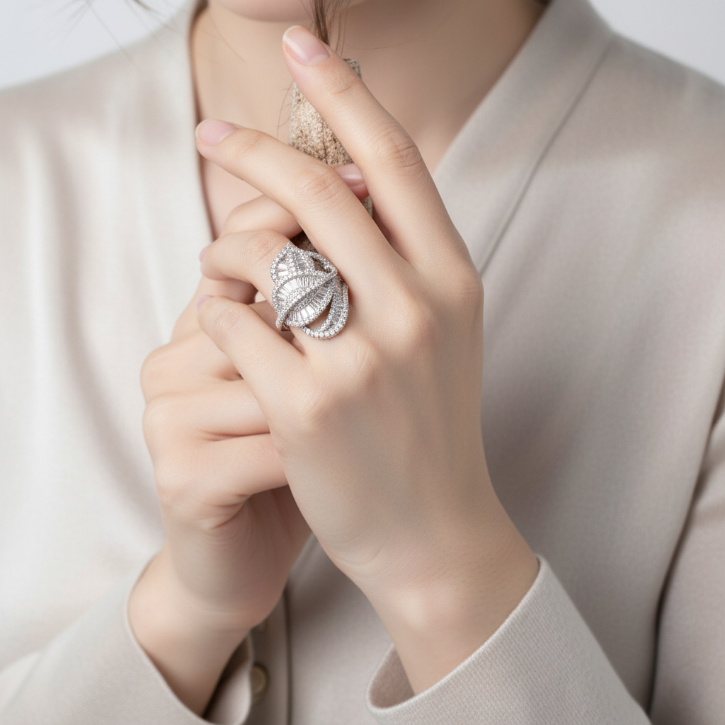 Close-up of a hand wearing a Regalia Crystal Ring with a diamond, against a neutral background.