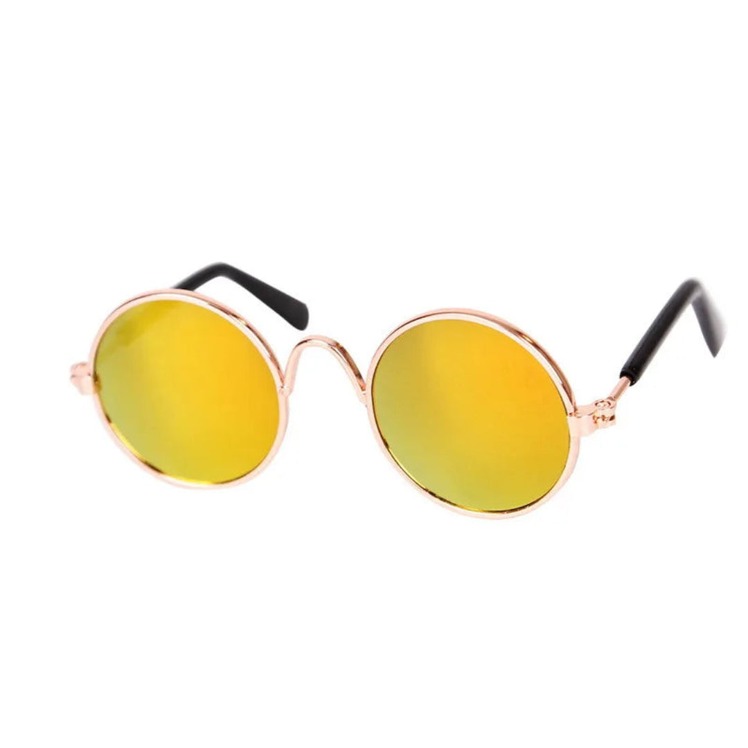 Round sunglasses with yellow lenses and rose gold frames on a white background