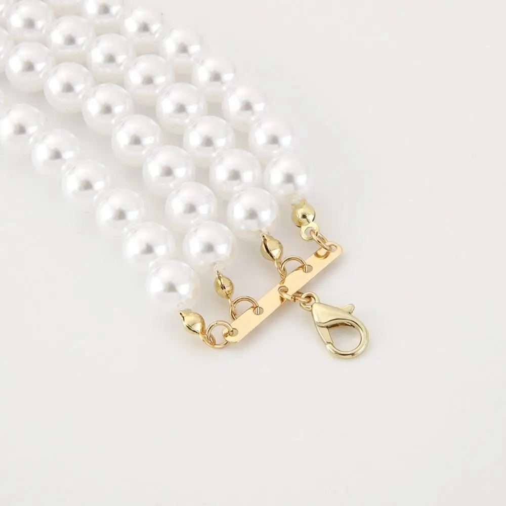 Pearl necklace with a gold clasp on a white background