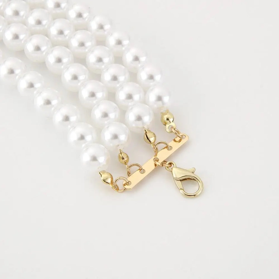 Pearl necklace with a gold clasp on a white background