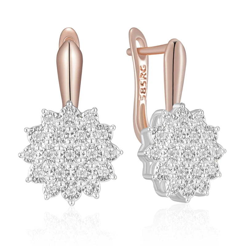 Rose gold and silver earrings with diamond-like stones on a white background