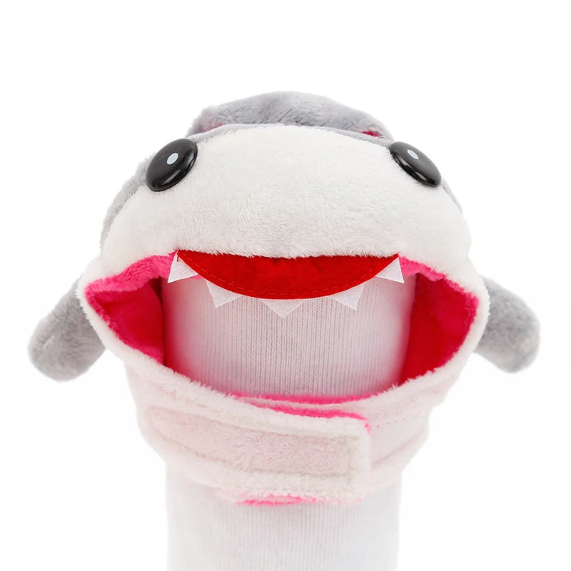 Plush shark toy with a white face, gray fins, and red mouth on a white background