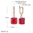 Rose gold earrings with red gemstones and measurements on a white background