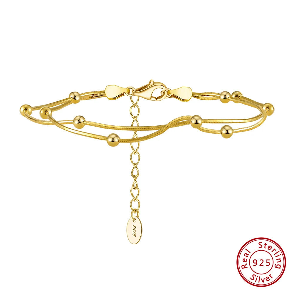 Gold bracelet with a tag and 'Real Sterling Silver' stamp on a white background, featuring Orsa Jewels brand.