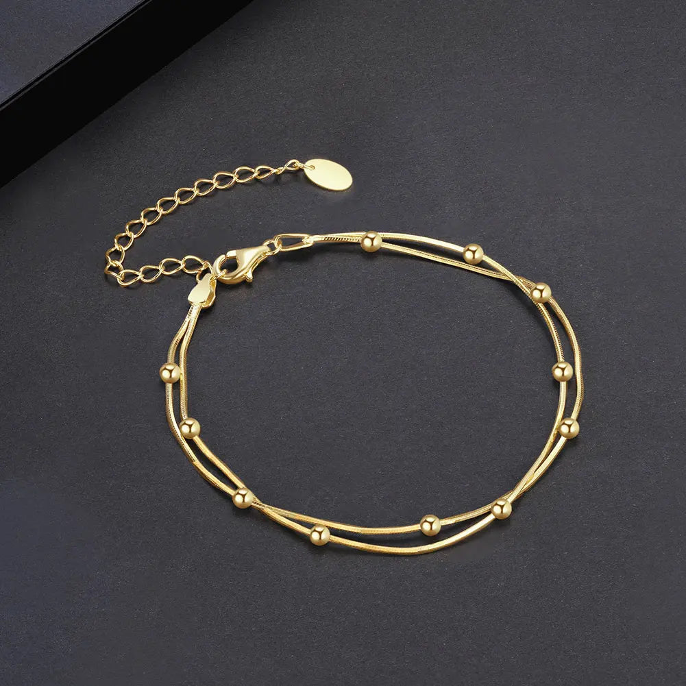 Gold bracelet on a dark gray background