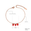 Rose gold anklet with red beads on a white background