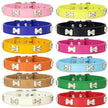 Collection of colorful dog collars with bone-shaped studs on a white background