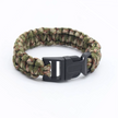 Camouflage-patterned paracord bracelet with a black buckle on a white background