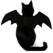 Black cat wearing a bat costume with large wings on a white background