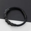 Black braided bracelet on a dark gray background