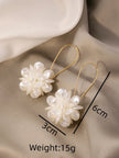 Floral earrings with measurements and weight on a beige fabric background
