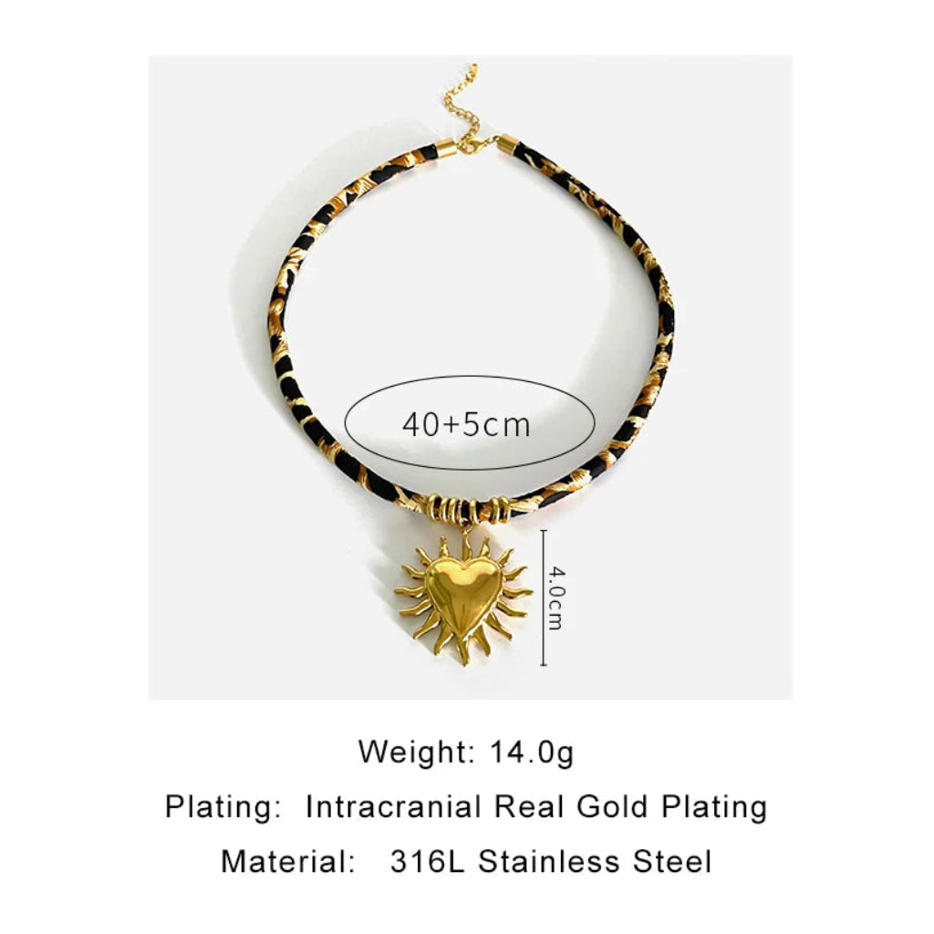 Necklace with gold heart pendant and tortoiseshell chain on a white background