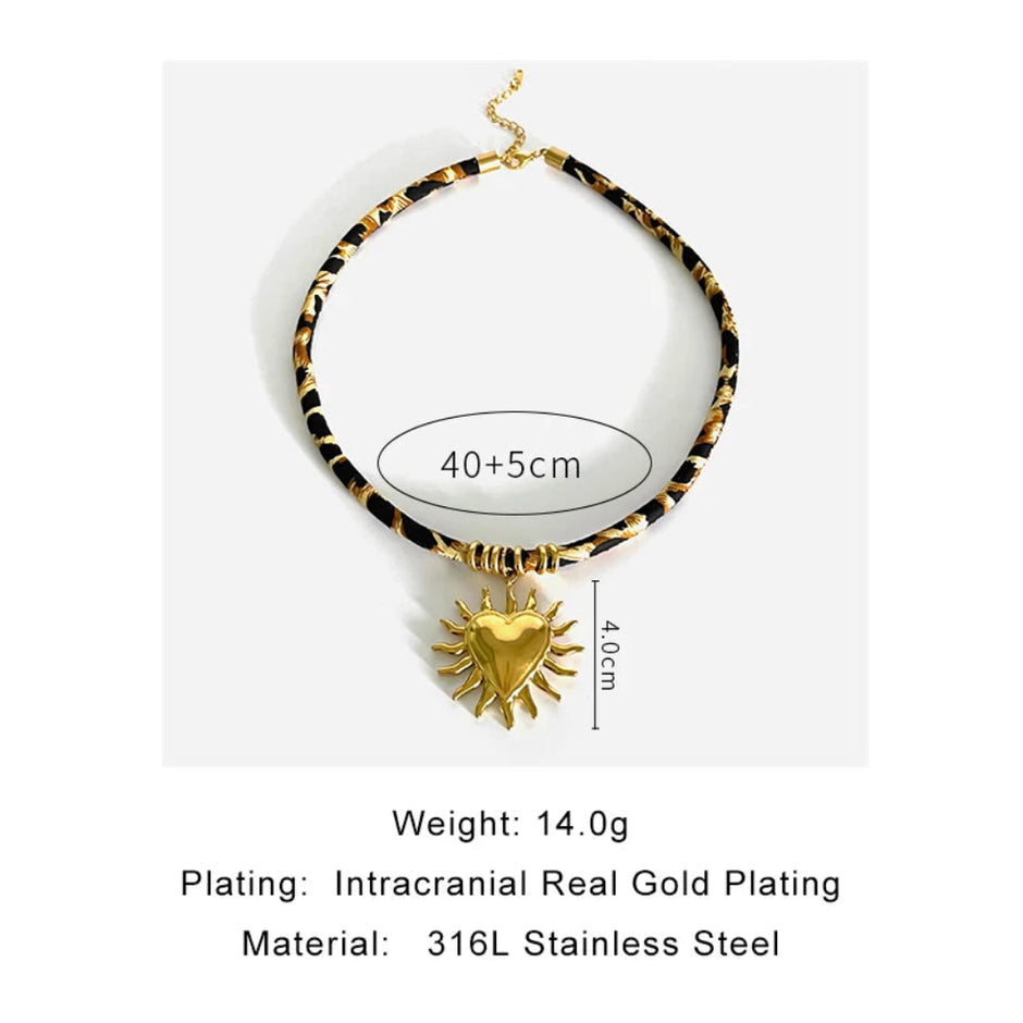 Necklace with gold heart pendant and tortoiseshell chain on a white background