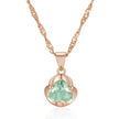 Rose gold necklace with a heart-shaped green gemstone pendant on a white background
