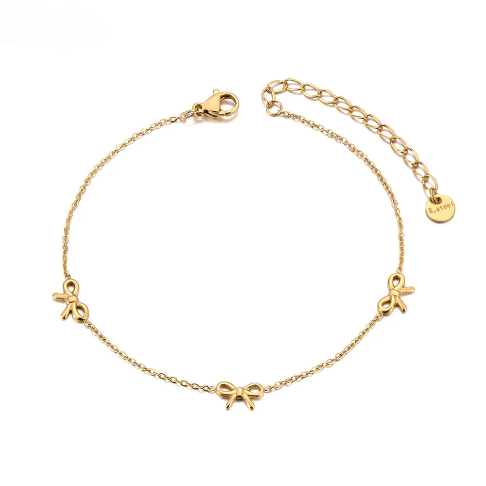 Gold anklet with bow charms on a white background, featuring the brand 'JeeMango'.