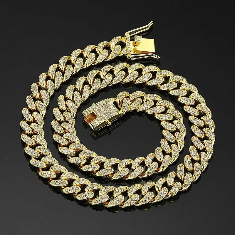 Gold chain necklace with diamond-like stones on a black background