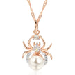Spider-shaped pendant with pearl and gemstones on a white background