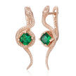 Rose gold snake-shaped earrings with green gemstones on a white background