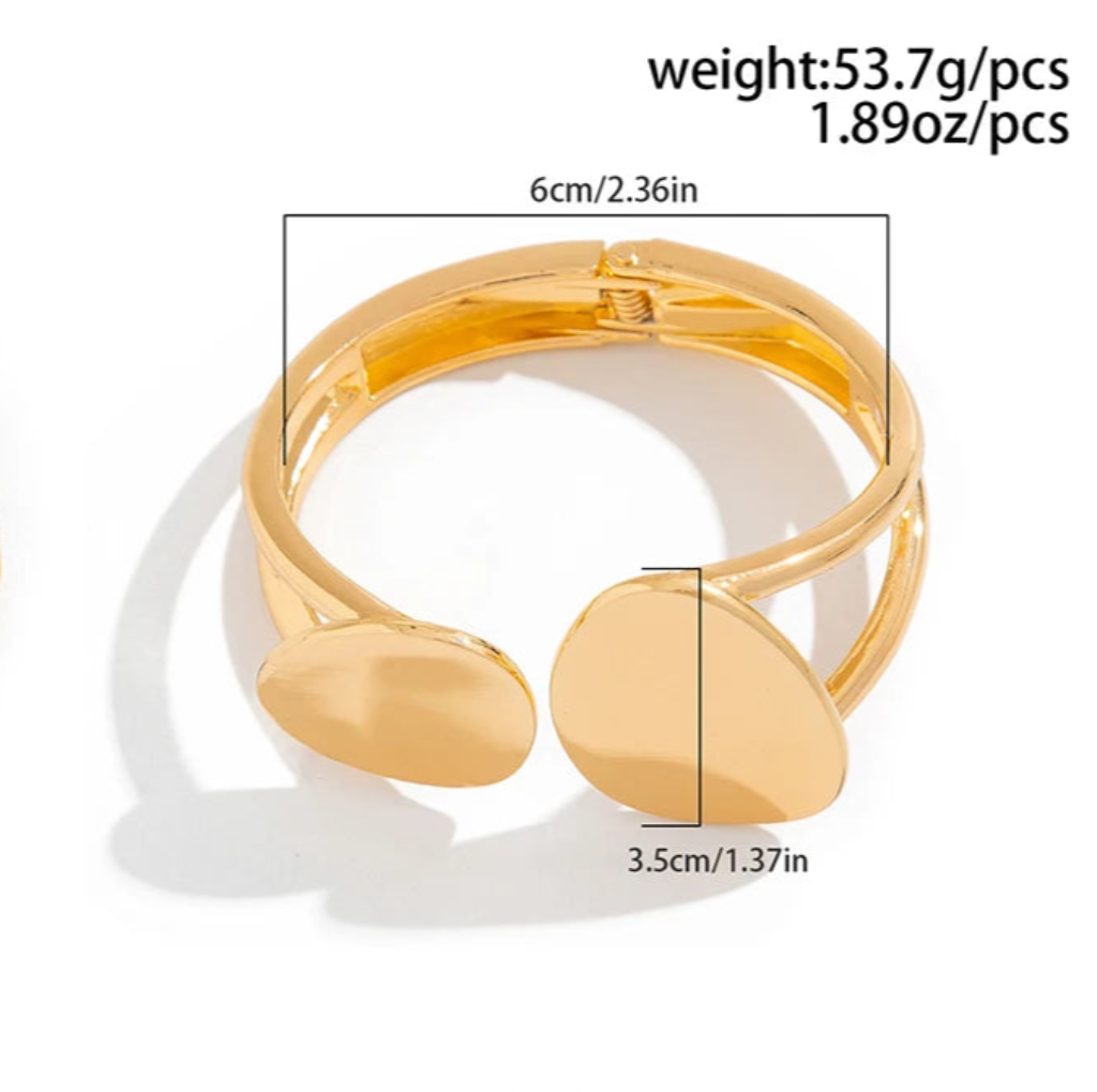 Gold bangel with measurements and weights on a white background
