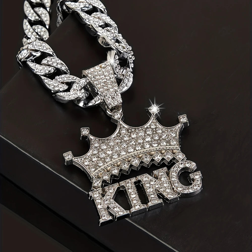 Silver chain necklace with 'KING' pendant on a dark background