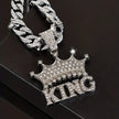Silver chain necklace with 'KING' pendant on a dark background