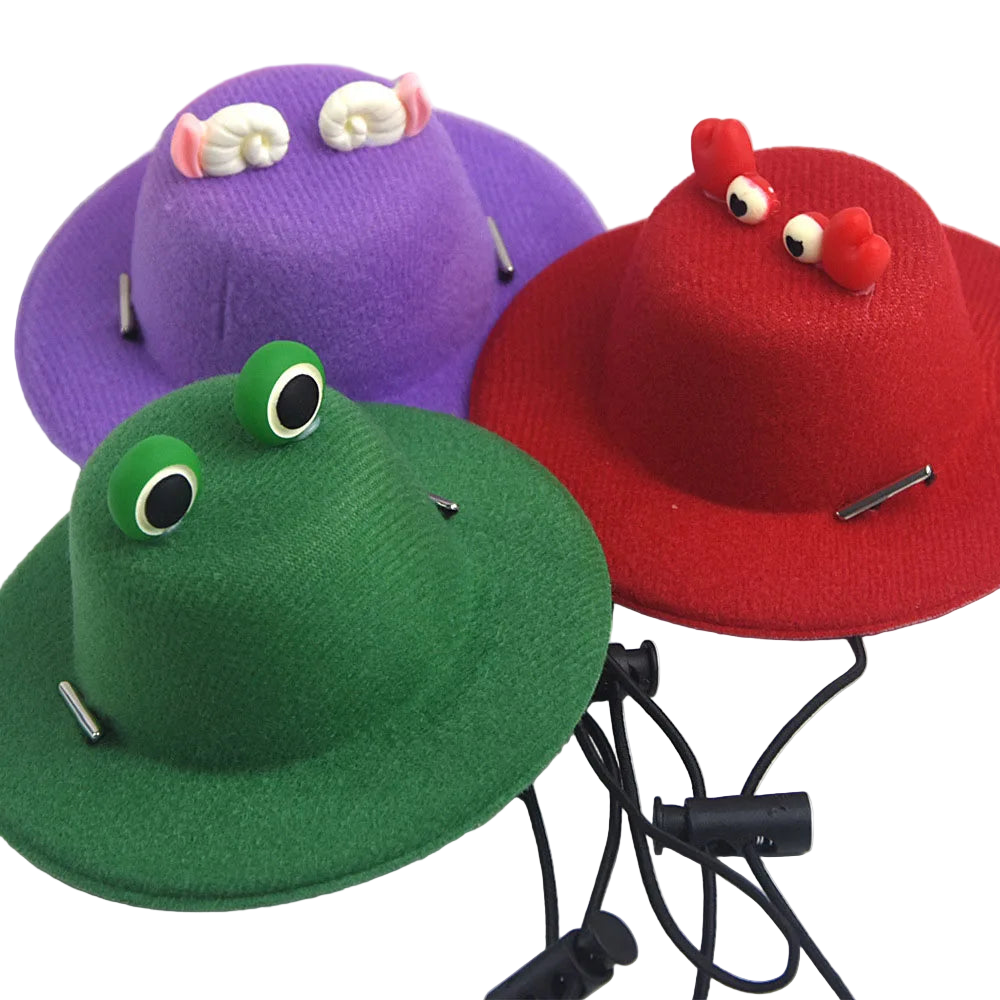 Three colorful hats shaped like a frog, purple creature, and red creature with wires attached on a white background.