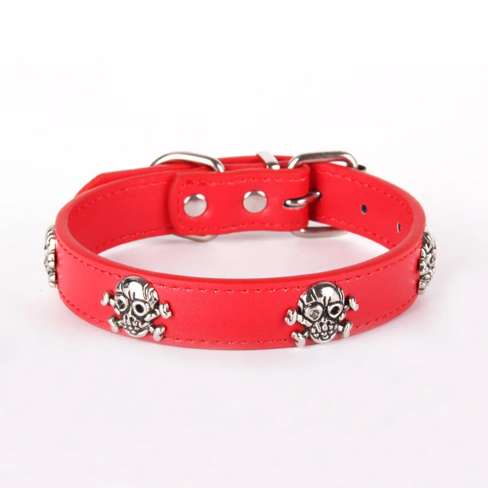 Red dog collar with silver skull decorations on a white background