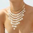 Pearl necklace with gold chain on a mannequin against a light background